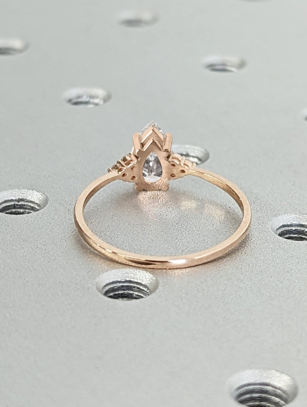 Pear cluster engagement ring finished in polished solid gold