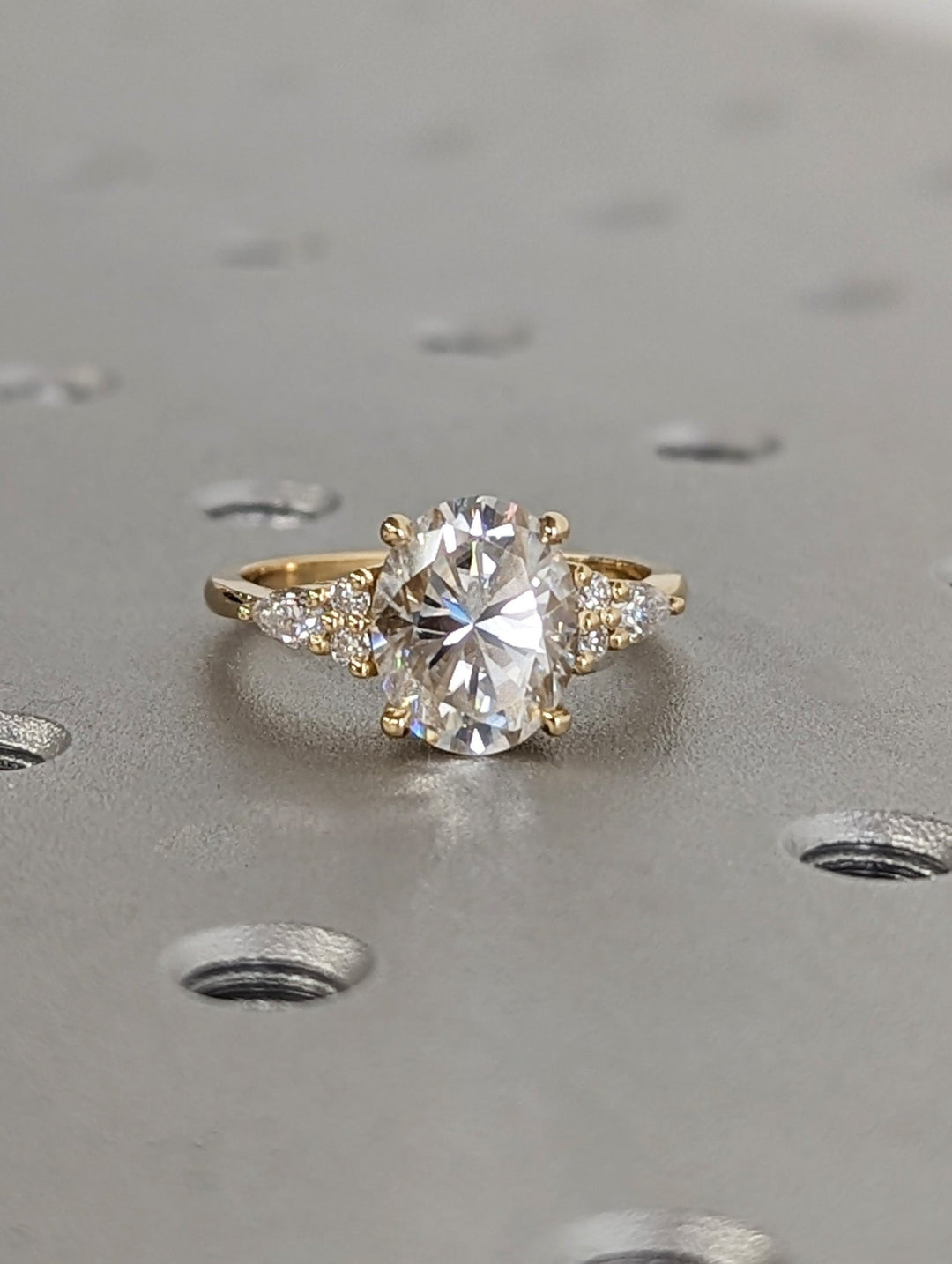 Detailed close-up of oval cluster diamond engagement ring
