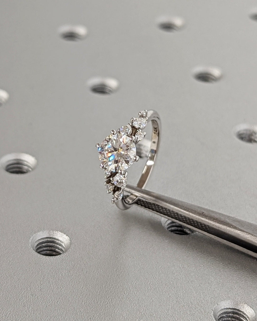 Round cluster engagement ring close-up highlighting diamond sparkle