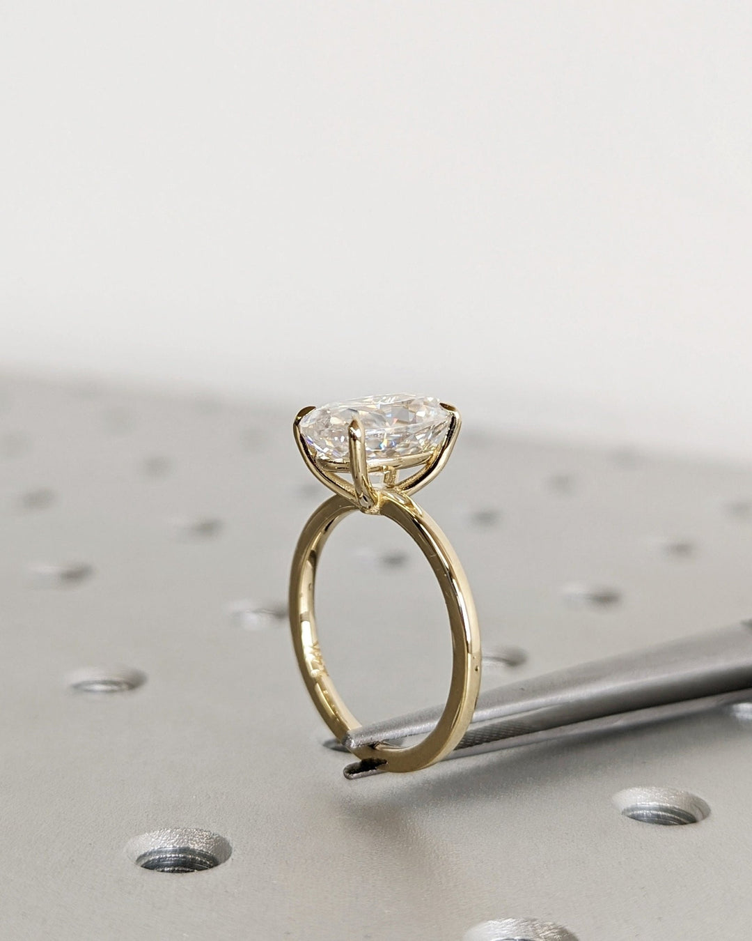 Oval solitaire engagement ring viewed from the side