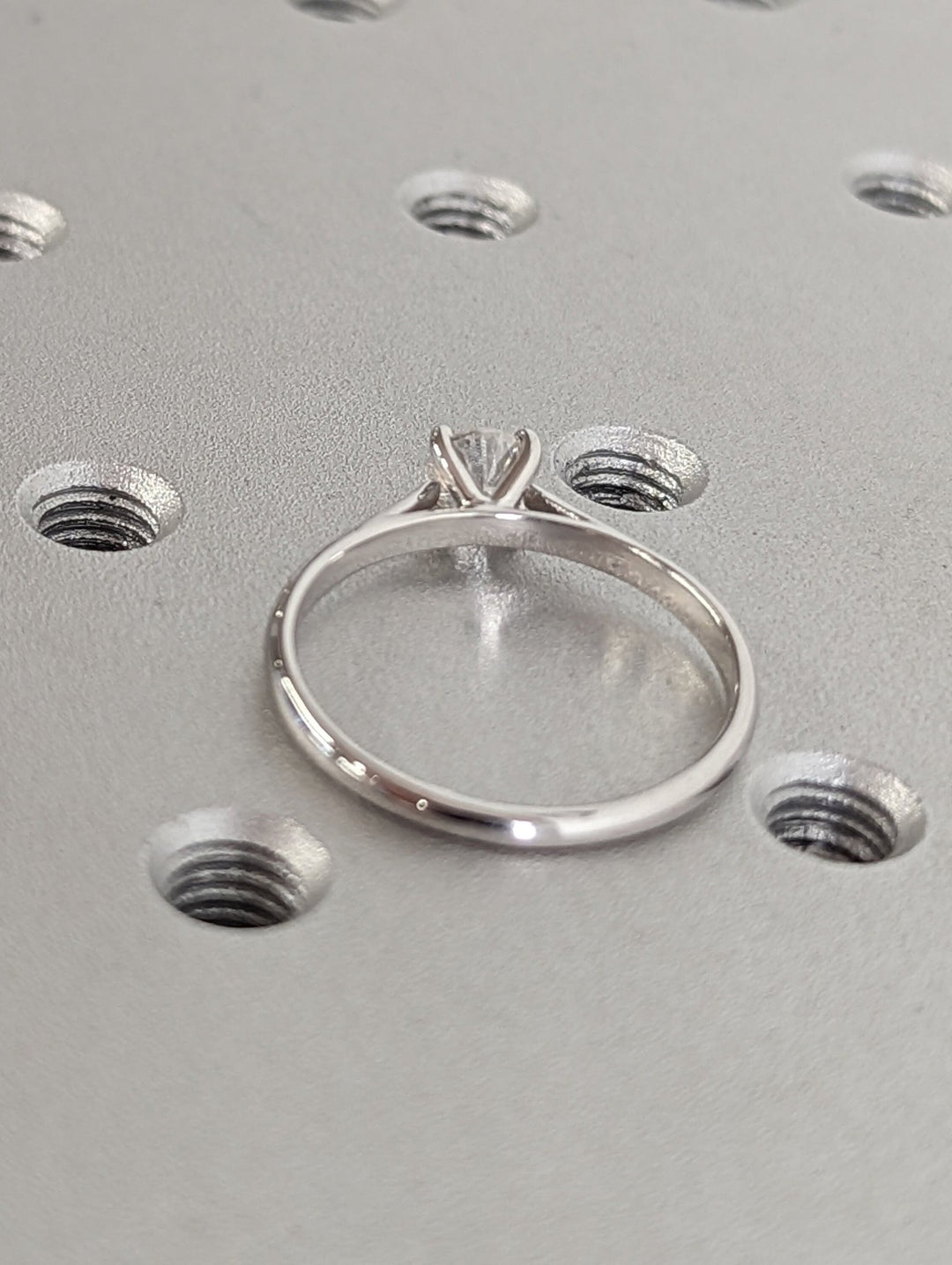 Side angle of round solitaire diamond engagement ring