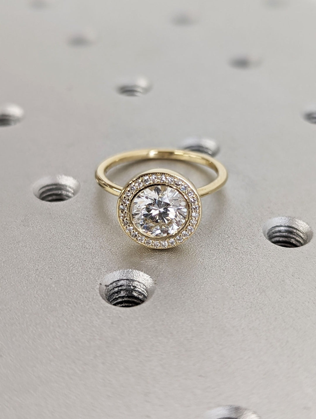 Round solitaire engagement ring finished in polished solid gold
