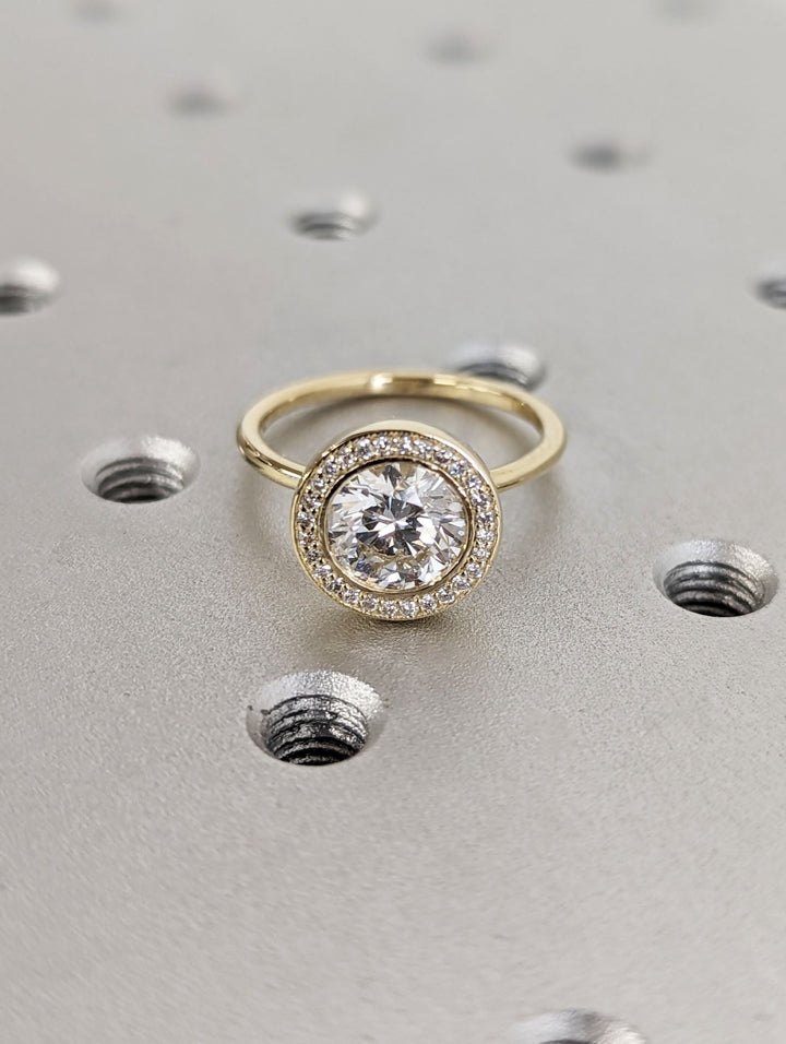 Round solitaire engagement ring finished in polished solid gold