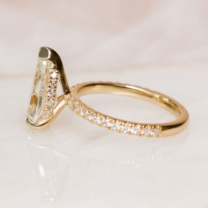Pear cut engagement ring side view showing band detail