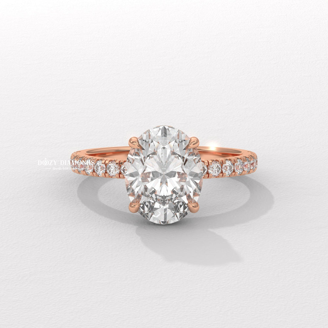 Oval hidden halo engagement ring viewed from the side