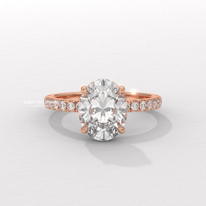 Oval hidden halo engagement ring viewed from the side