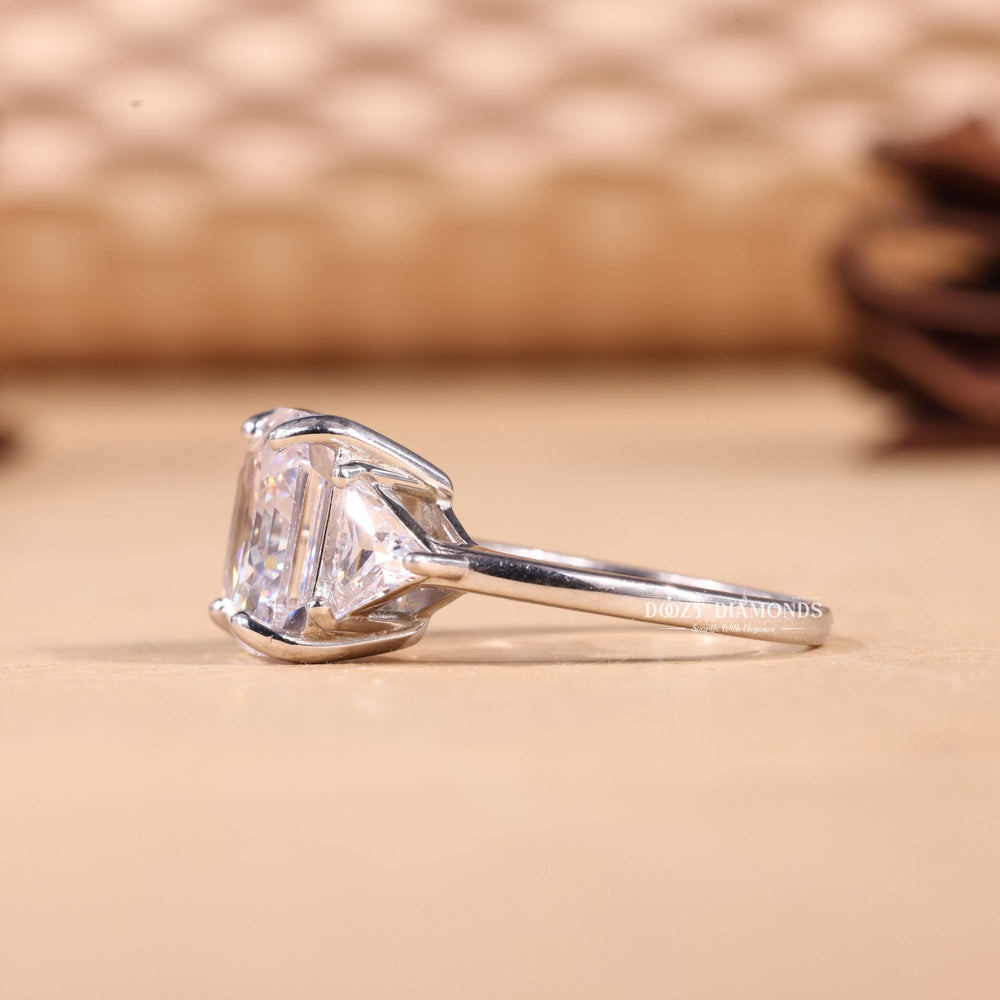 Asscher three stone diamond ring presented in signature gift packaging
