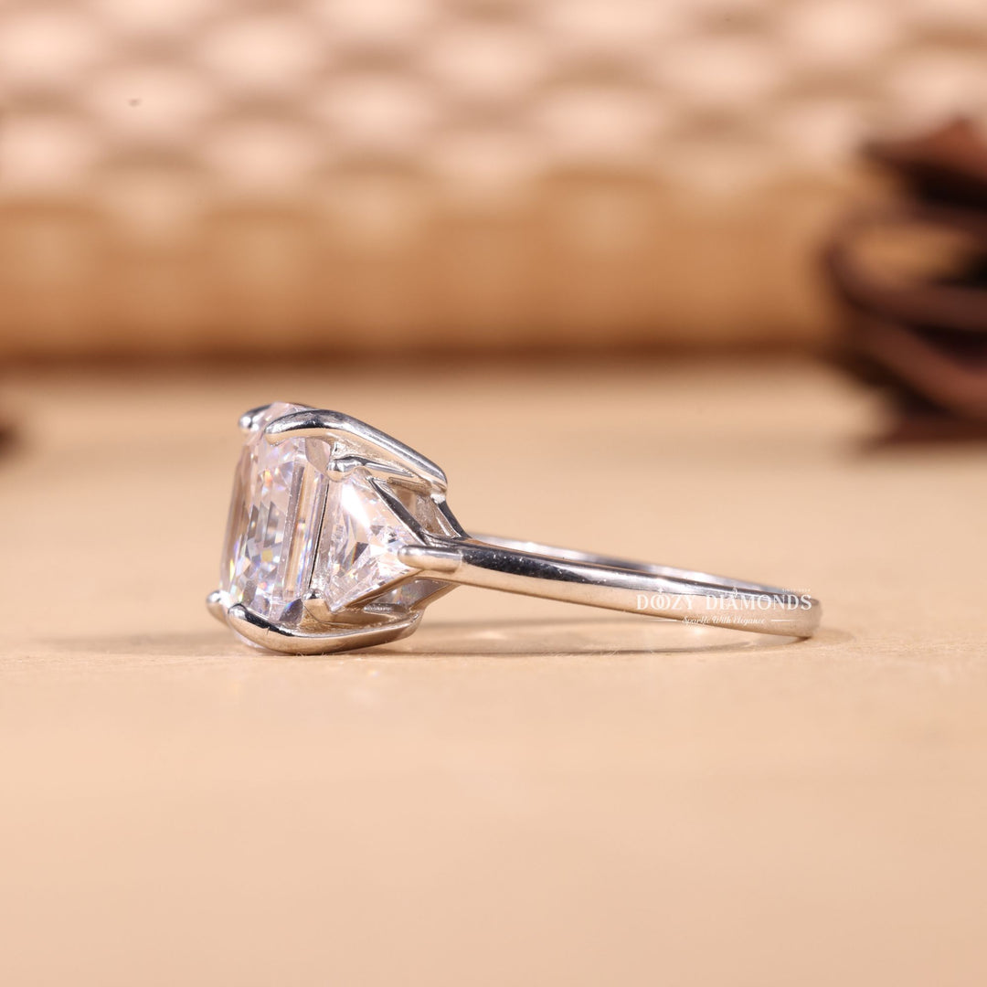 Asscher three stone diamond ring presented in signature gift packaging