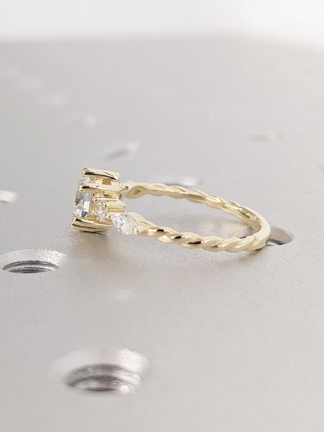 Angled view of round cut diamond in cluster setting