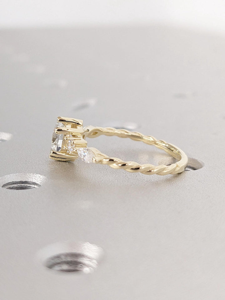 Angled view of round cut diamond in cluster setting