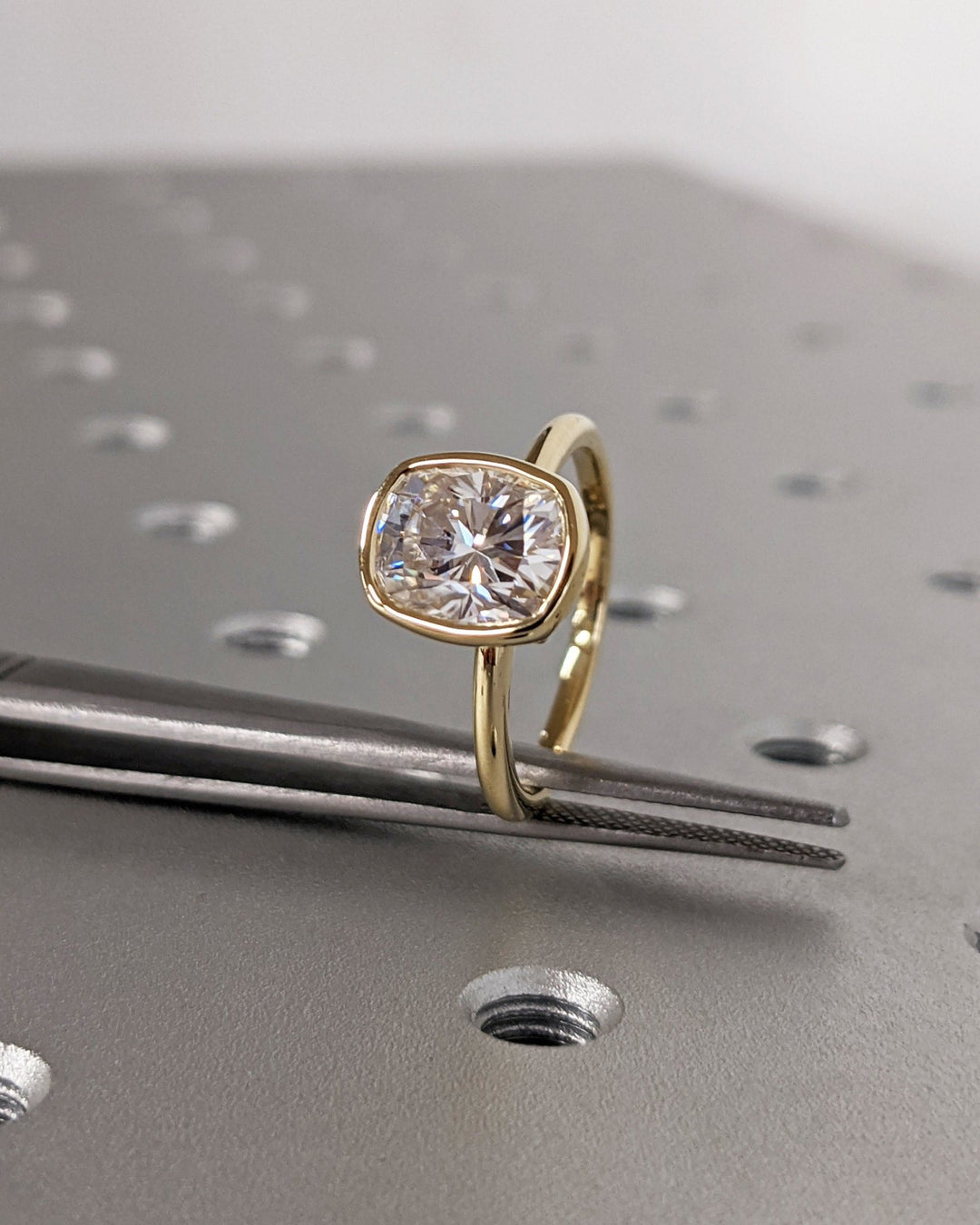 Cushion cut diamond ring worn on hand