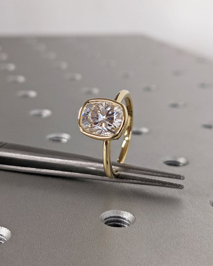 Cushion cut diamond ring worn on hand
