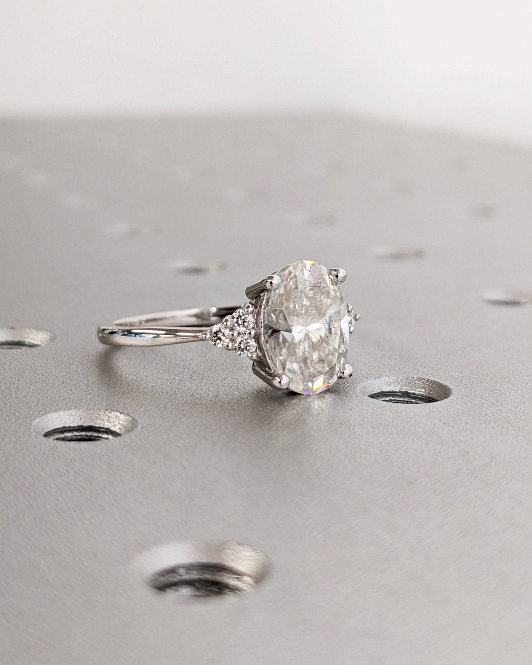 Macro shot of oval cut diamond facets in cluster ring setting