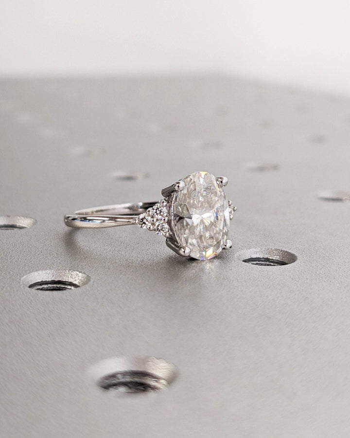Macro shot of oval cut diamond facets in cluster ring setting