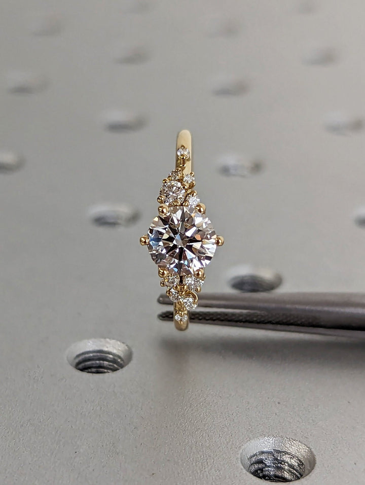 Unboxing view of round cut cluster diamond engagement ring