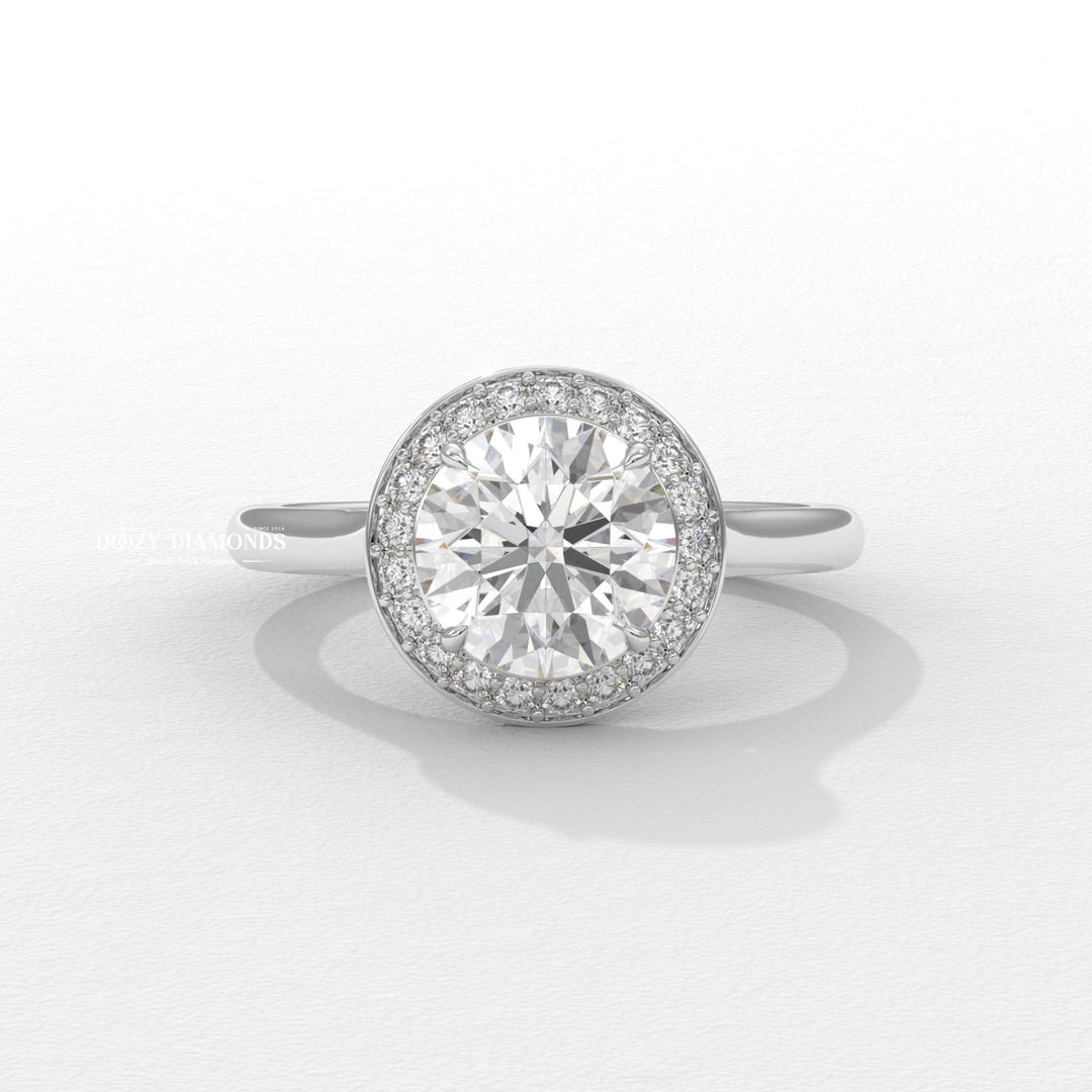 Round halo diamond ring displayed on jewelry stand