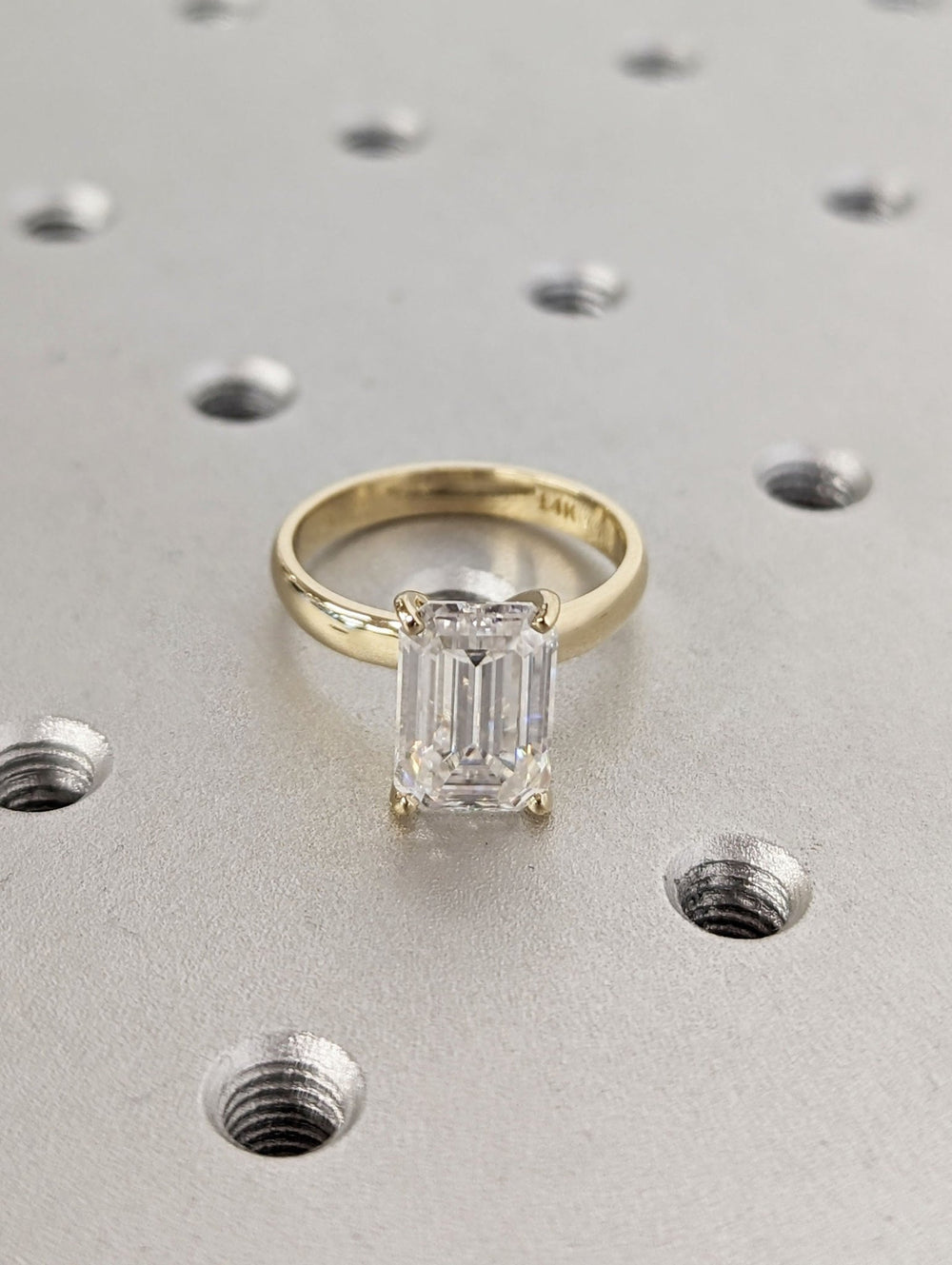 Emerald solitaire engagement ring close-up highlighting diamond sparkle