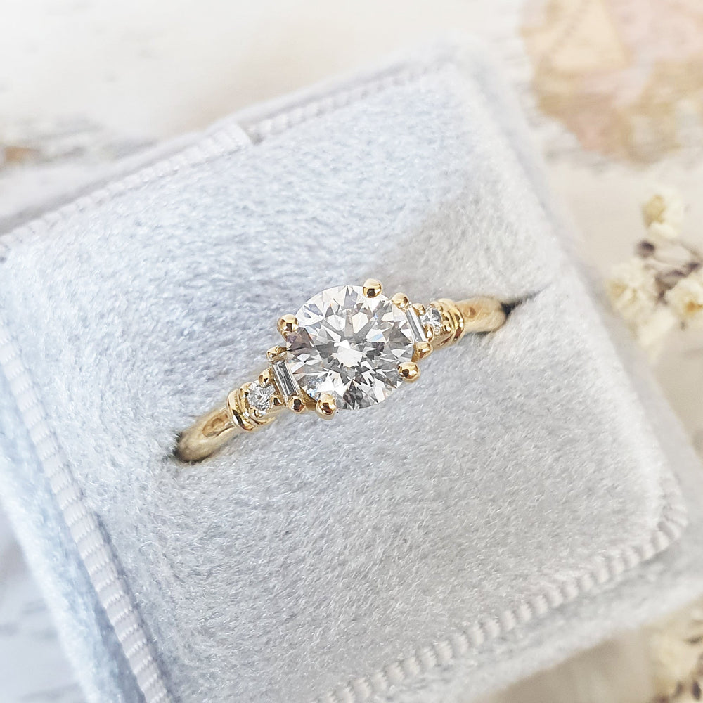 Round cluster engagement ring photographed in natural light