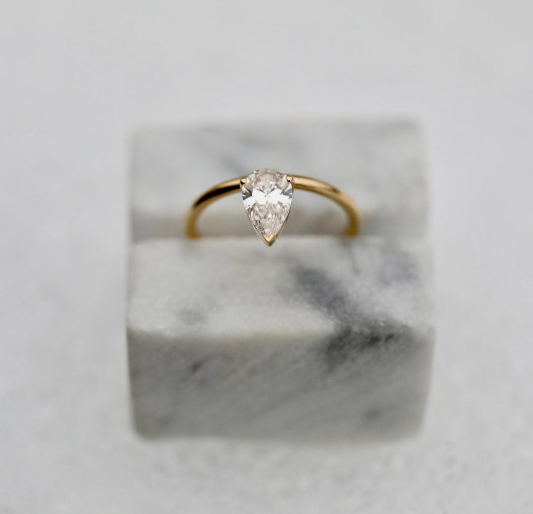 Fine craftsmanship detail on pear solitaire engagement ring