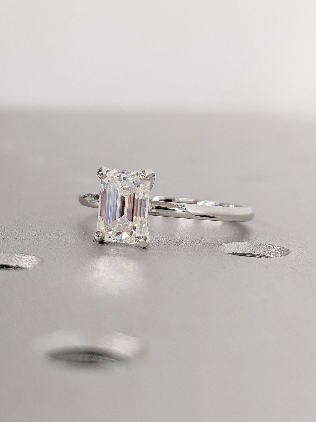 Macro shot of emerald cut diamond facets in solitaire ring setting