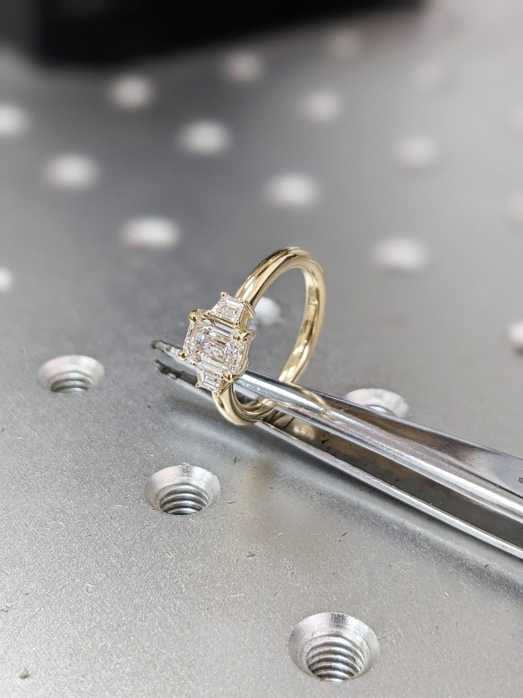 Side angle of emerald solitaire diamond engagement ring