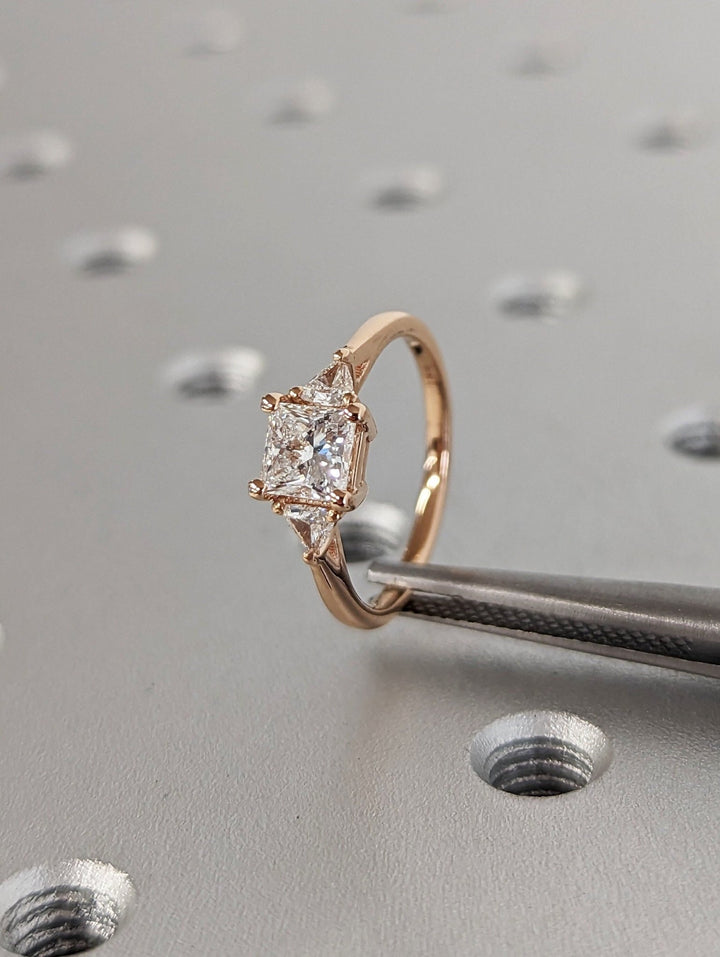 Princess three stone engagement ring close-up showing high clarity diamond clarity