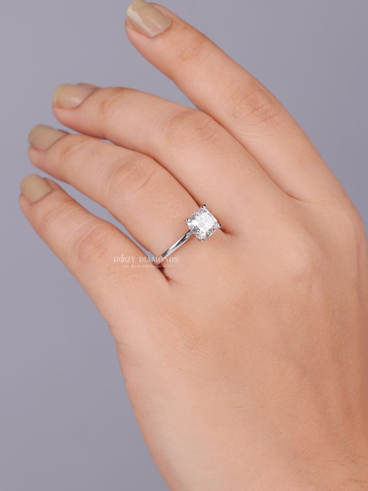 Cushion solitaire diamond ring displayed on jewelry stand