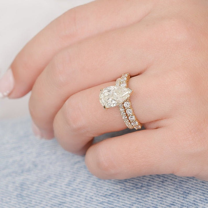 Pear hidden halo engagement ring shown on hand for true-to-life sizing