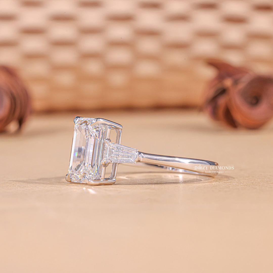 Premium emerald cut three stone engagement ring crafted in solid gold