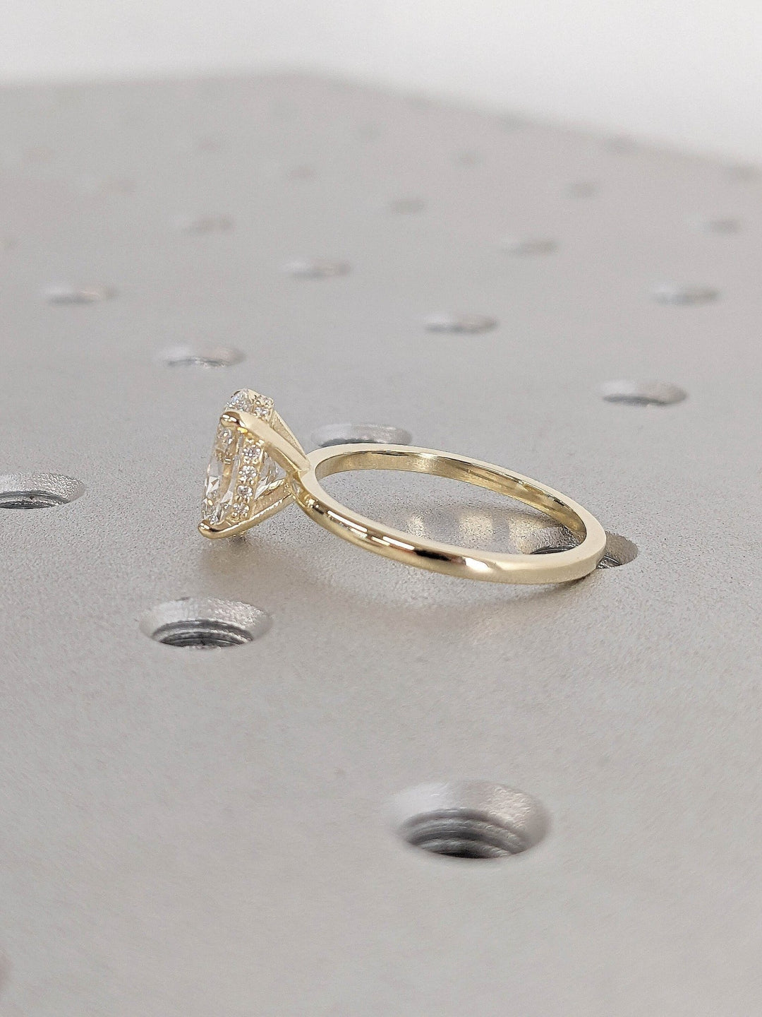Oval hidden halo lab grown diamond ring fitted on finger