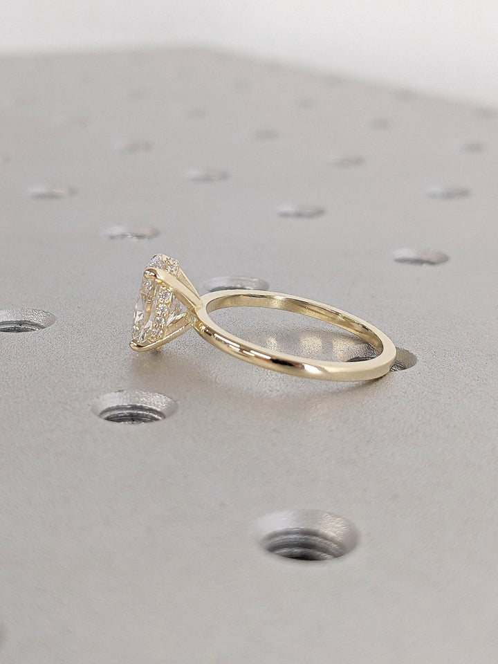 Oval hidden halo lab grown diamond ring fitted on finger
