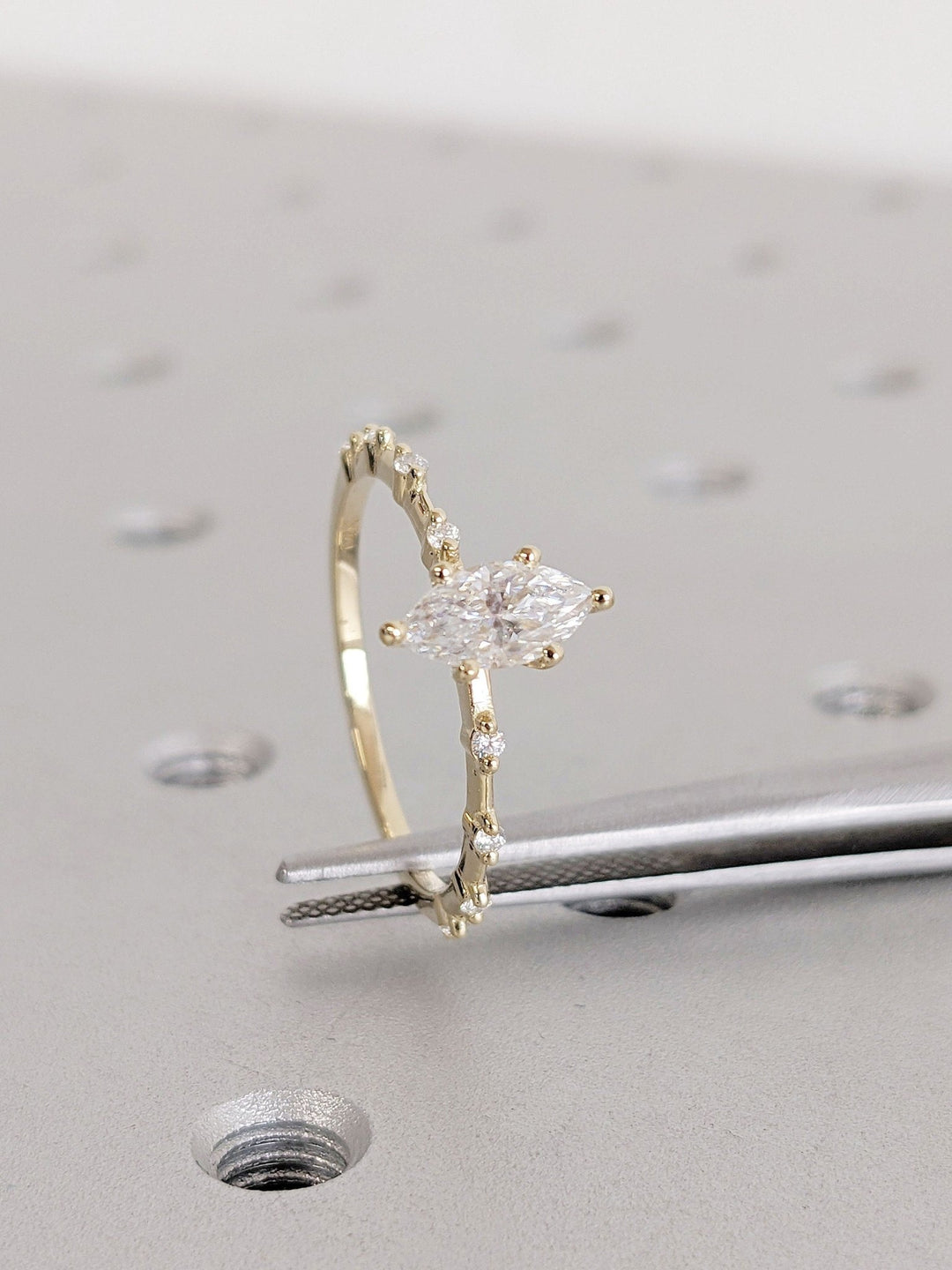 Marquise cut engagement ring shown with authenticity certificate