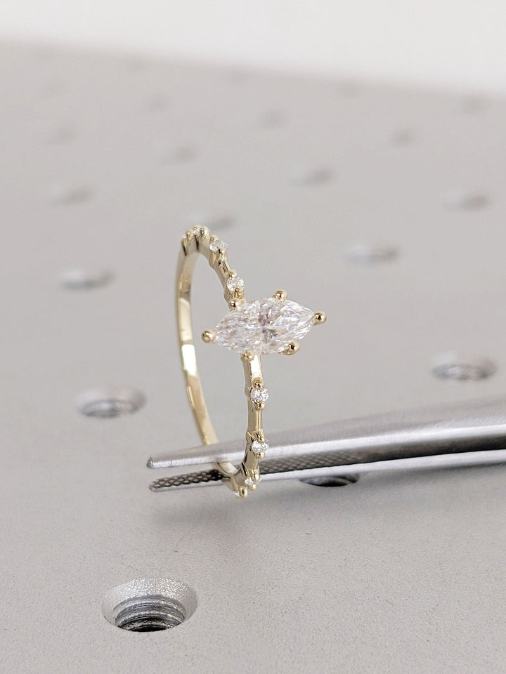 Marquise cut engagement ring shown with authenticity certificate
