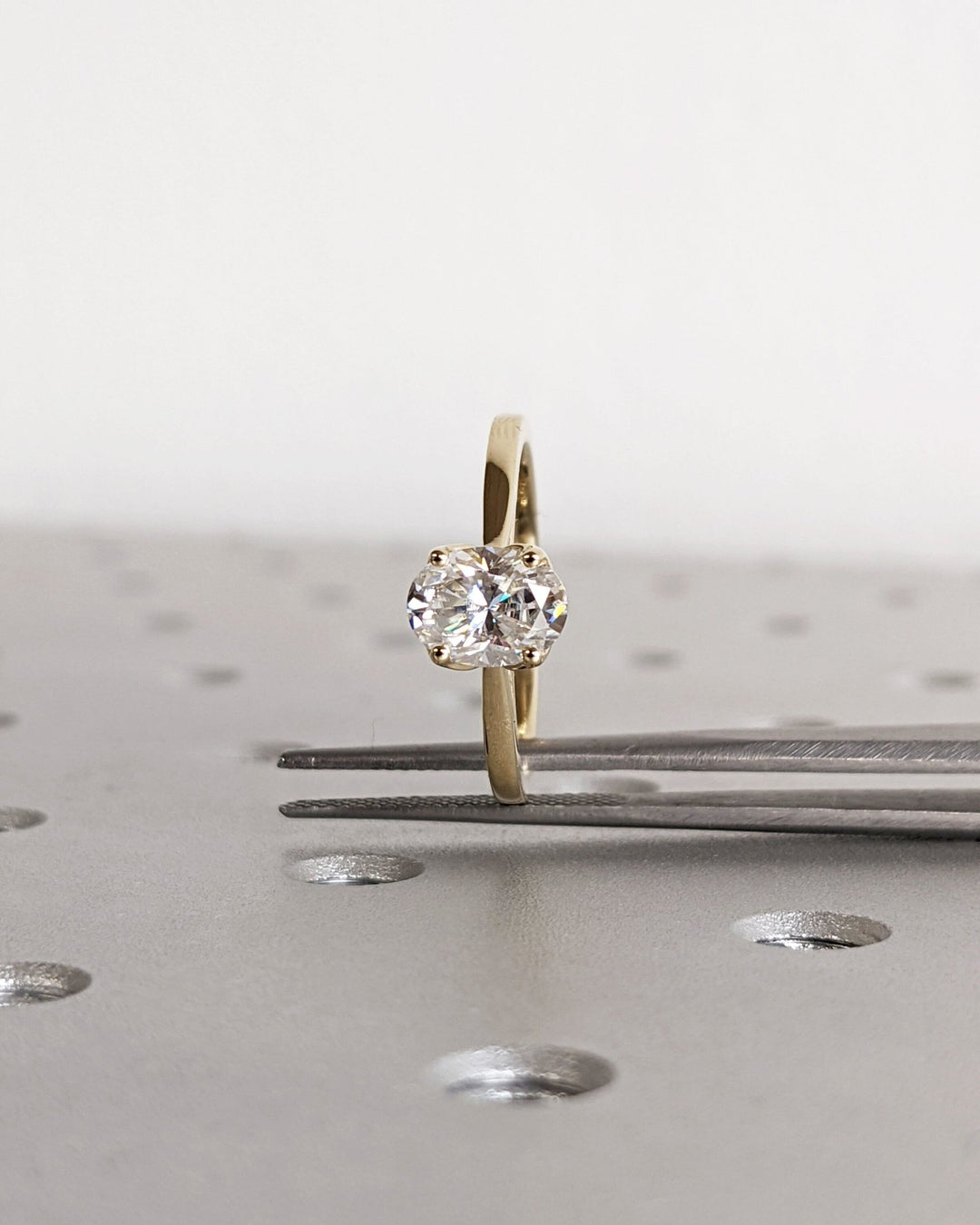 Close-up of oval cut center diamond in solitaire engagement ring