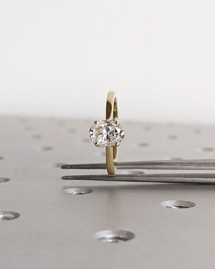 Close-up of oval cut center diamond in solitaire engagement ring