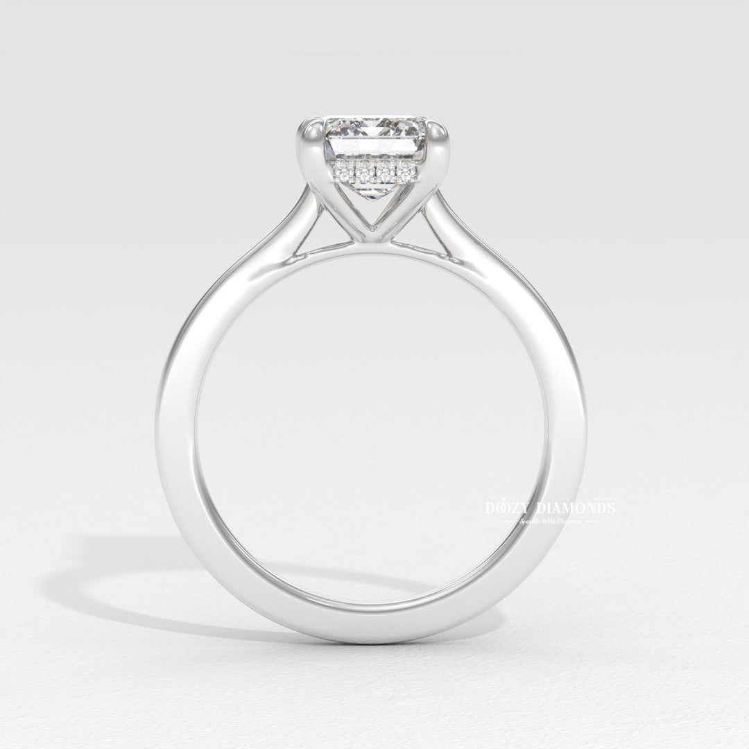 Fine craftsmanship detail on emerald hidden halo engagement ring