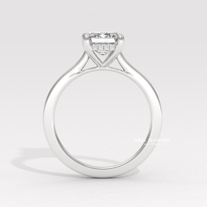 Fine craftsmanship detail on emerald hidden halo engagement ring