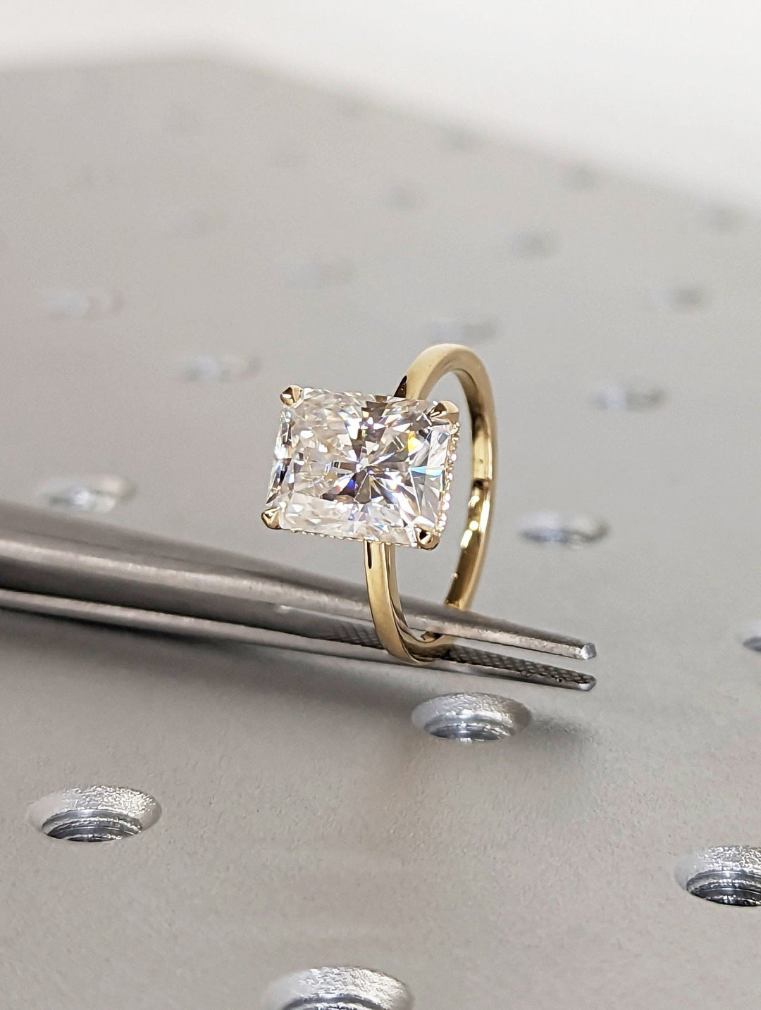 Fine craftsmanship detail on radiant hidden halo engagement ring