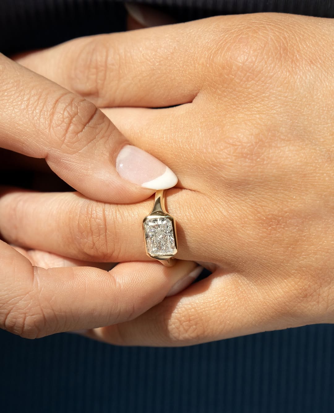 Detailed close-up of radiant bezel diamond engagement ring