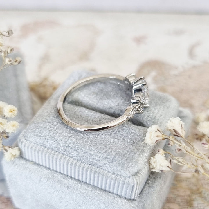 Pear cluster engagement ring finished in polished solid gold