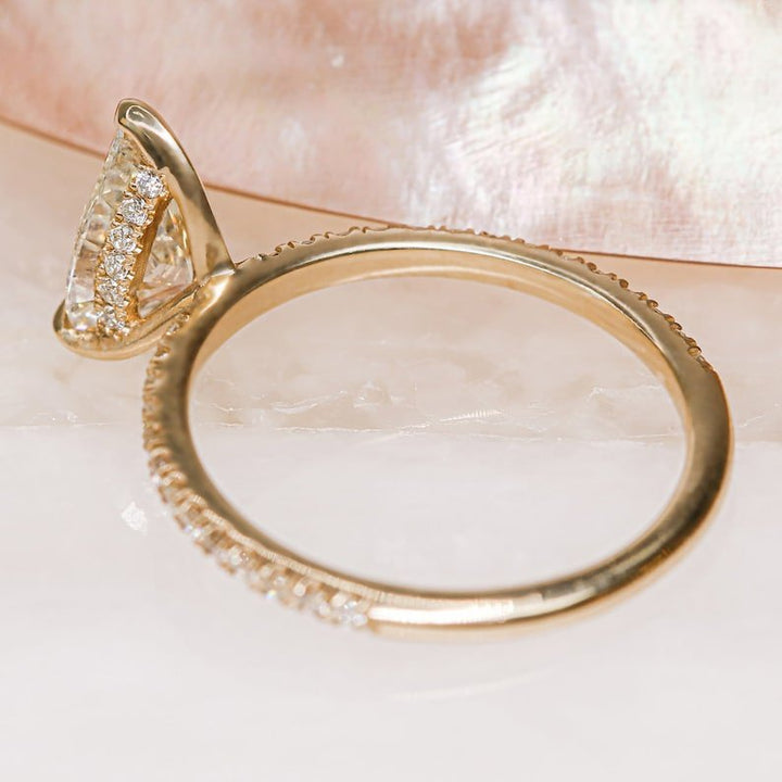 Pear hidden halo lab grown diamond ring side profile in gold setting