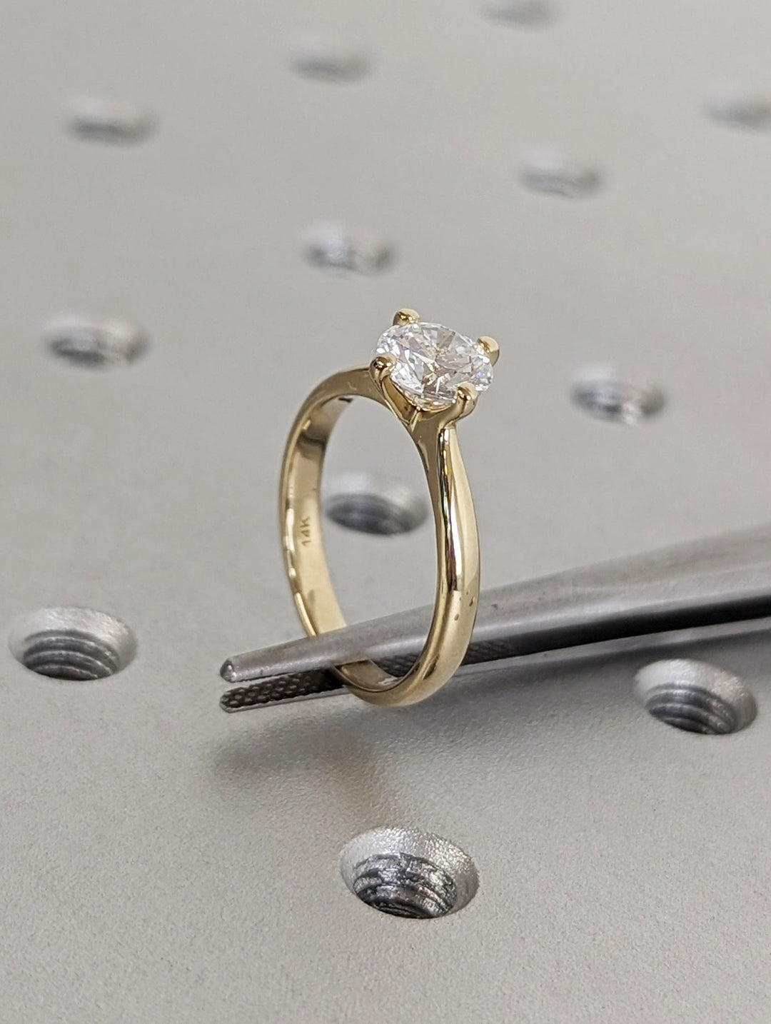 Detailed close-up of round solitaire diamond engagement ring