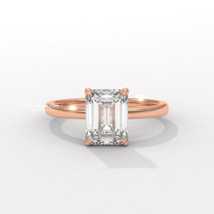 Emerald solitaire engagement ring with brilliant diamond sparkle