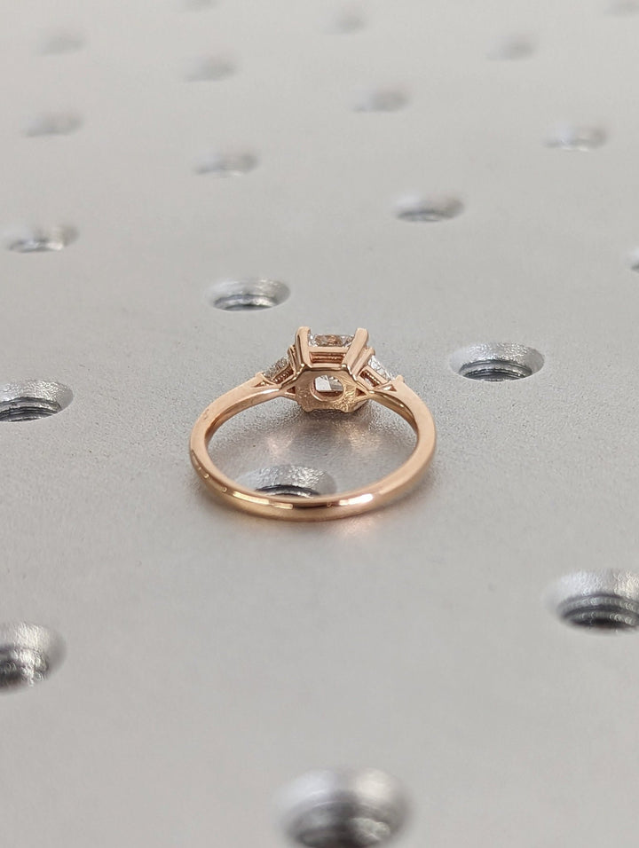Top-down view of princess cut three stone engagement ring