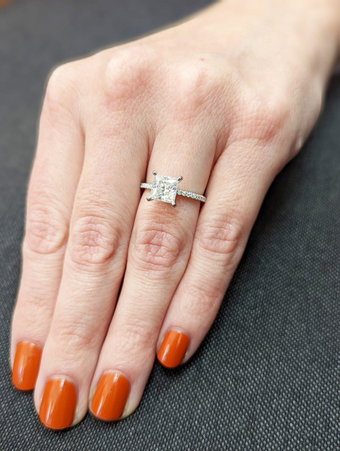 Macro shot of princess cut diamond facets in pave ring setting