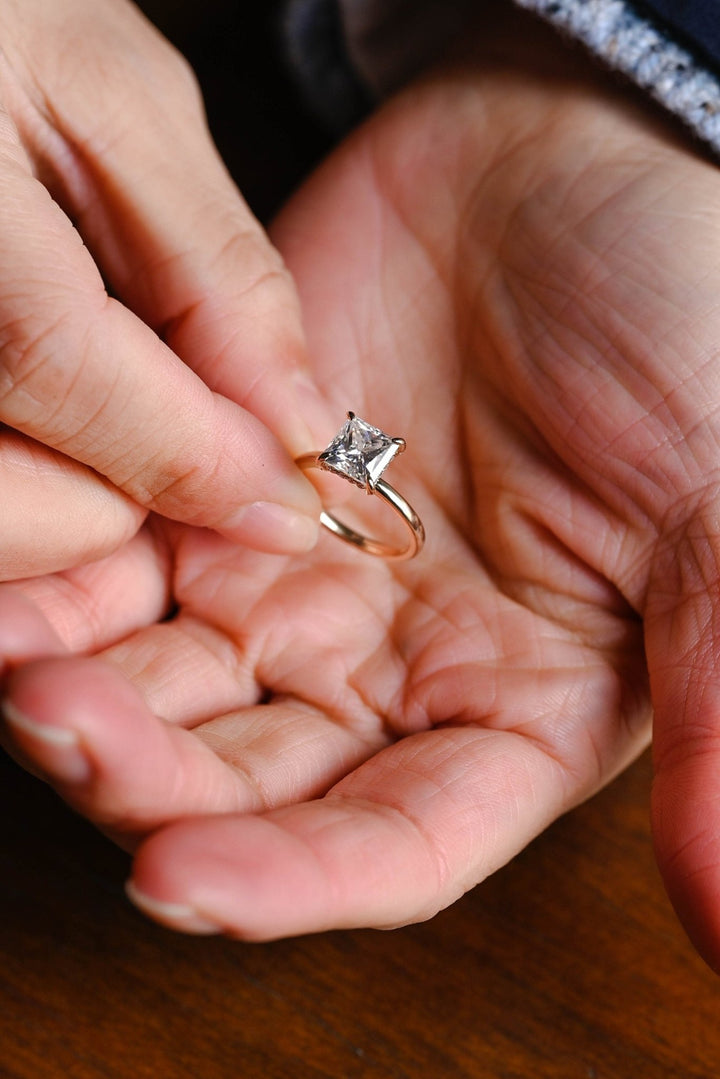 Princess hidden halo engagement ring offered in gold and platinum