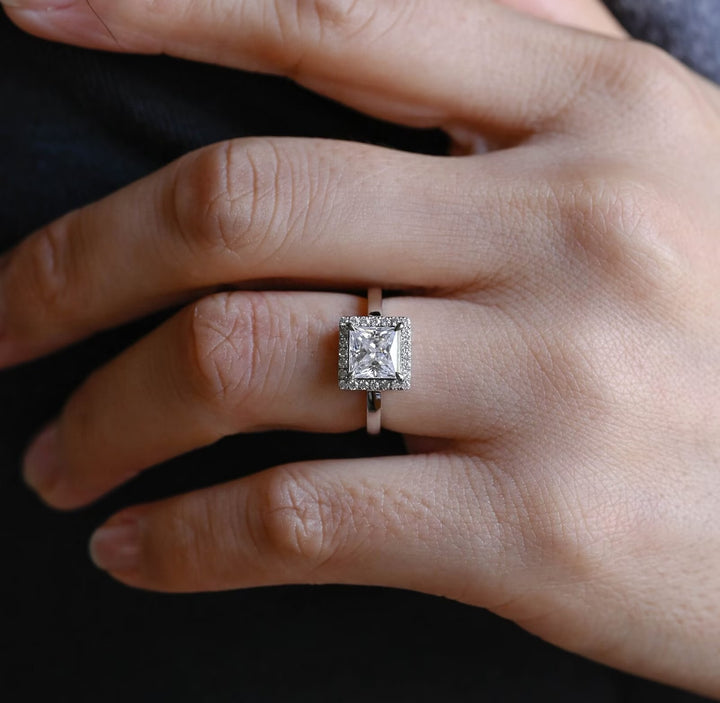 Princess halo engagement ring photographed in natural light