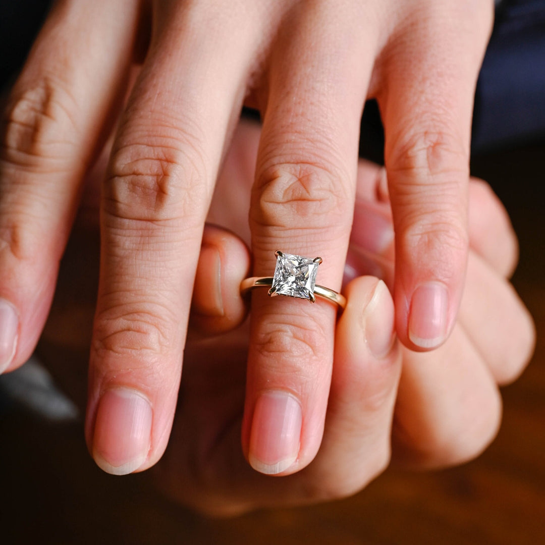 Princess hidden halo diamond ring presented in signature gift packaging