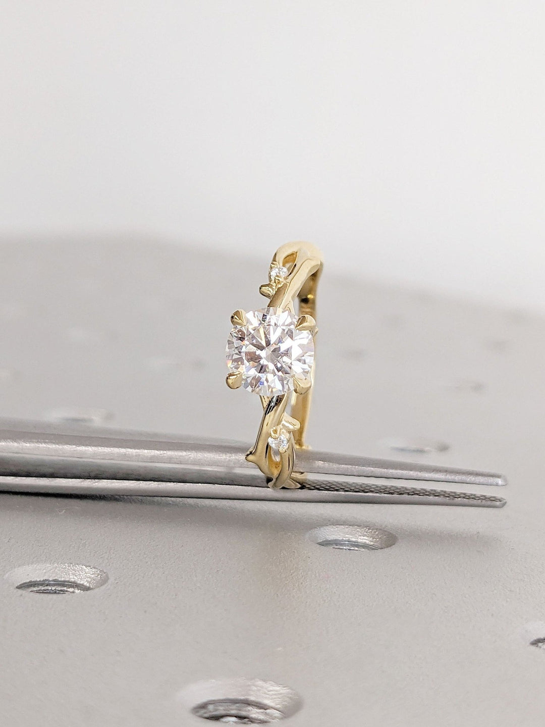 Round solitaire diamond engagement ring available in multiple metals