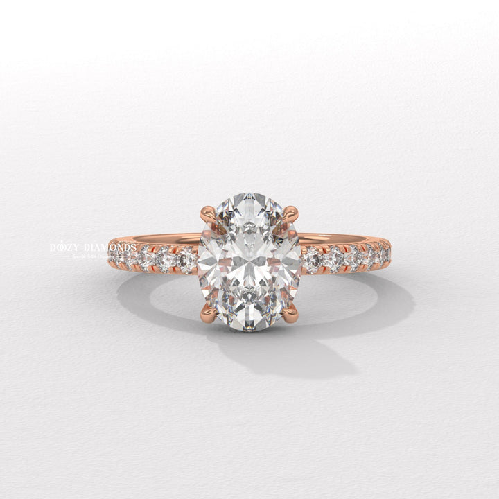Oval hidden halo engagement ring close-up highlighting diamond sparkle